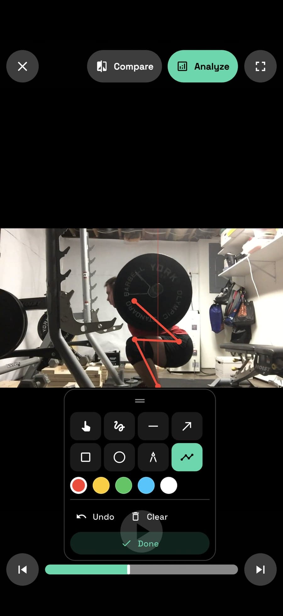Unrack Analyze mode — a path traced through the bar of a paused squat against a vertical reference line, with the drawing tool tray open above the frame scrubber