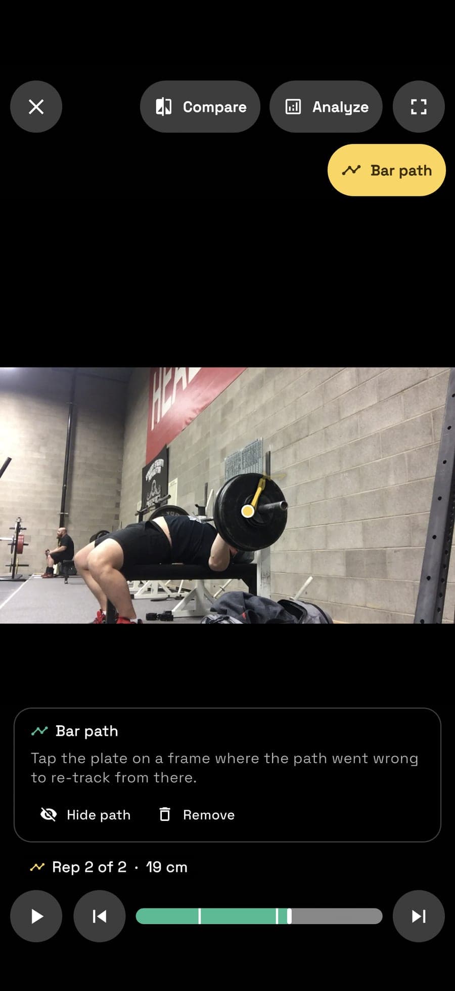 Unrack Bar path — the bar's path traced in gold over a bench press clip, reading rep 2 of 2 and 19 cm